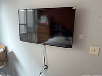 Front view of wall-mounted Samsung TV showing screen and bezel