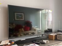 Front view of LG 55-inch LED TV and Boston Acoustics soundbar on media console