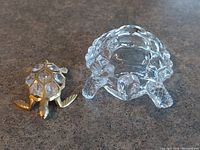 Both turtle figurines shown side by side on a surface.