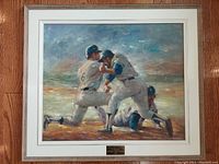 Framed original oil painting titled "Home Plate" showing three baseball players during a game moment near home plate.