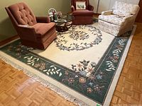 Wide view of the large floral area rug with surrounding furniture showing overall size and design.