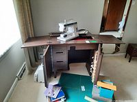 Wide shot of sewing table with doors open and sewing machine on top