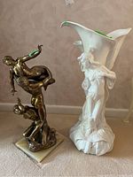 Both porcelain vase and metal sculpture side by side