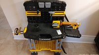 Front view of the Toy Workman workbench showing attached pegboard and included toy tools (hammer, wrench, and others).