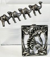 Front and side view of sterling silver brooch shaped as five camels in a row with tarnishing.