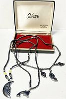 Three vintage hematite beaded necklaces displayed with owner box; show pendants and overall necklace design