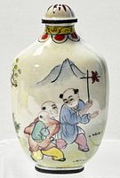 Front view of the oval cloisonné enamel perfume bottle featuring hand-painted children playing and nature motifs.