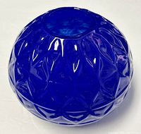 Top view of the deep blue embossed glass vase showing geometric patterns and circular opening.