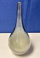 Full view of the genie bottle vase showing the bulbous body and tall narrow neck with white cased smoked glass.