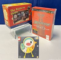 Photo showing Thomas the Tank Engine Collector’s Box Set, Janod Bird Xylophone box, and NHL Anaheim Ducks Stanley Cup DVD Box Set.