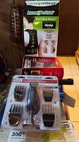 Photo of Wahl Peanut trimmer in blister pack, Remington Micro Screen shaver box, and Hemp Arrow Posture strap box