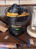Full view of Vacmaster wet/dry vacuum showing hose, power cord, and overall unit condition.