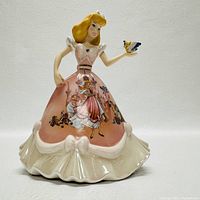 Front view of the Cinderella figurine bell showing detailed dress artwork and bird held on her finger.