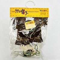 Photo of The Muffy Collection Pocahoppy brown fabric outfit in original sealed packaging with branded yellow header card and accessories inside.