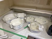 Photo of multiple Corning Ware Blue Cornflower casserole dishes including 2 with glass lids and one extra lid