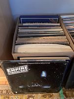 Box of multiple LP records showing Star Wars Empire Strikes Back LP cover in front
