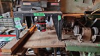 Full view of Sears Craftsman router table showing the metal legs, wooden top and the motor installed underneath.