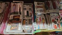 Two bins filled with vintage sewing patterns including Vogue, New Look, Butterick, Simplicity and McCall's.