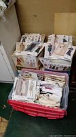 Two plastic bins filled with assorted pattern envelopes