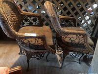 Pair of wicker chairs side by side showing overall form and cushion pattern