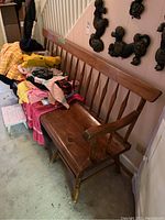 Front view of bench showing full length seat and backrest, clothes covering seat