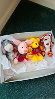 Box with 5 Disney Winnie the Pooh plush toys including Eeyore, Piglet, Pooh with holiday bows