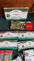 Boxes of Christmas lights showing 100-bulb and multiple 50-bulb sets in various colors and packaging condition
