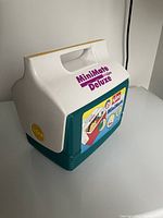 Front side view of the Igloo MiniMate Deluxe mini cooler with brand label and handle visible.