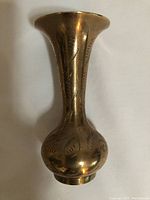 Front view of brass vase showing etched leaf pattern and overall shape