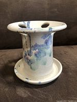 Front-side view showing the holder structure with holes and glazed color accents.