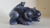 Side angled view of the onyx spirit box showing the bear body and frog lid detail
