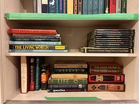 Shelf view showing Broken Empire, To the Ends of the Earth, Birds of Canada, The Living World and stack of audio discs