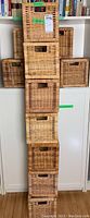 Stack of 12 wicker baskets showing front and side views, highlighting variation in color and weave pattern.