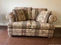 Front view of the two-seat couch showing fabric pattern and cushions.