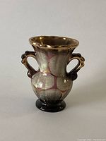 Front view of the vase showing multicolor gold and silver glazed finish and two handles.