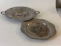 View of both silver plate trays together showing size difference and overall condition