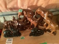 Group photo of all seven elephant statues showing various sizes and materials.