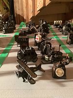 Photo featuring the metal miniatures arranged in rows including airplane, stagecoach, industrial engine, and rotary phone.