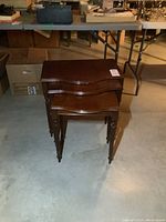 Three stacked wooden nesting tables viewed from above