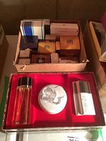 Two boxes full of assorted colognes and perfumes including boxed items and some small vials and bottles arranged in tray.
