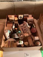 Overall photo of the box with multiple assorted perfume and toiletry boxes, showing quantity and variety.