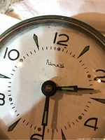 Close-up of Russian alarm clock dial with Cyrillic script