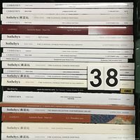 Stack of auction catalogs from Sotheby's, Christie's, Bonhams, Lempertz, and others, showing spines with titles focusing on Chinese art.