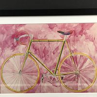 Close-up photo of the watercolor style bicycle artwork on pink-purple textured background, part of the print.
