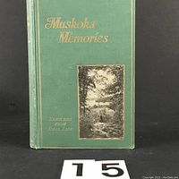 Front cover of green hardcover book titled 'Muskoka Memories: Sketches From Real Life' with scenic photographic illustration.
