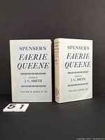 Two hardcover volumes of Spenser's Faerie Queene standing next to each other with white dust jackets, clean and neat.