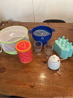 Full shot of all items showing mesh food cover, cookie canister, honey pot, glass cups, popcorn popper, and popsicle molds