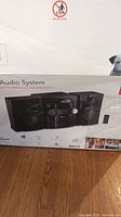 Photo of the RCA audio system box showing the front image of the system and speakers.