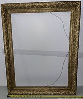 Full view of the rectangular antique frame showing overall size and condition with wire for hanging.
