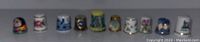 Full view of all 10 assorted thimbles in a single row on a flat surface.